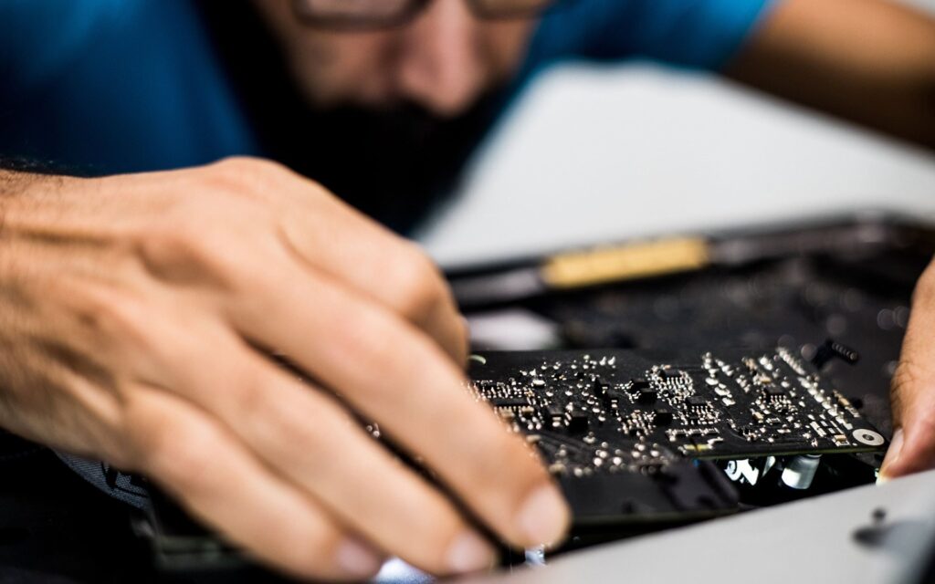 Hands repairing computer hardware